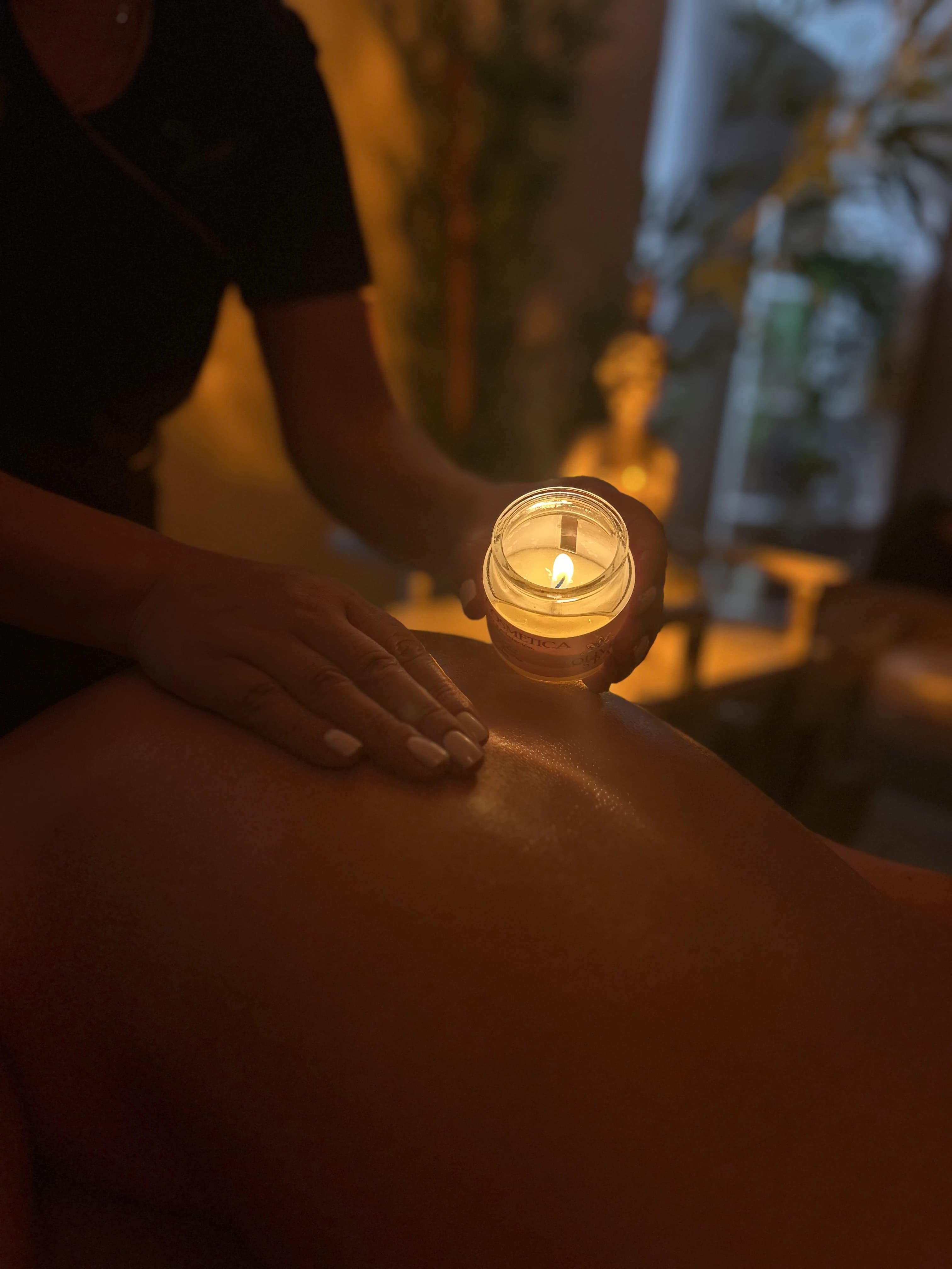 Candle over a woman's back